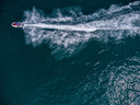 Groß (aerial-view-of-floating-scooter-on-blue-sea-at-sun-2023-11-27-05-31-00-utc).webp
